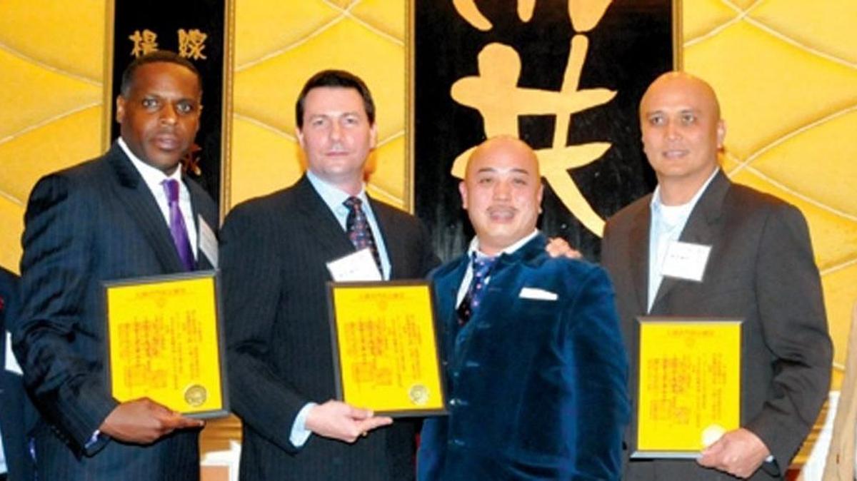 
In this photo taken March 16, 2011, Raymond “Shrimp Boy” Chow, second from right, poses with several inducted consultants, including Keith Jackson, left, a former San Francisco school board member, at the Chee Kung Tong spring banquet in San Francisco. 

