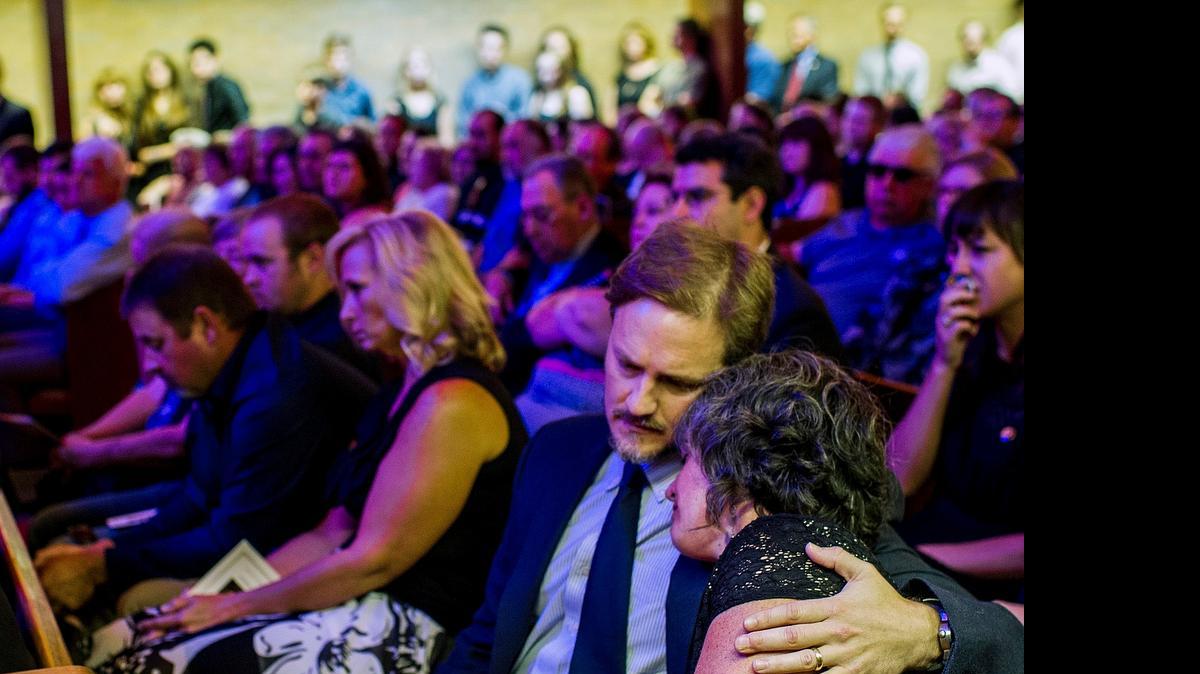 
Josh Caffery embraces Caroline Helm during the funeral service July 27 for their friend Jillian Johnson at Delhomme Funeral Home in Lafayette, Louisiana. Johnson was a victim of the The Grand 16 movie theater shooting in Lafayette on July 23. 
