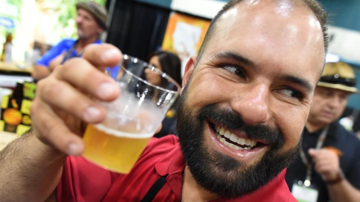 Zachary Missakian tries the Hand-Crafted Ginger Beer from Riley’s Brewing Company of Madera, during the Fresno Food Expo.