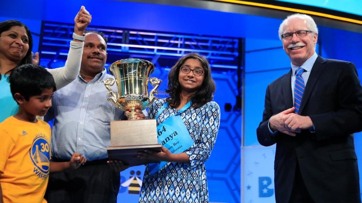 Ananya Vinay, 12, of Fresno, celebrates with her mother, Anupama Poliyedath, left, and father, Vinay Sreekumar, after being presented with a trophy by E.W. Scripps Company CEO Rich Boehne. She won the 90th Scripps National Spelling Bee in National Harbor, Maryland, Thursday, June 1, 2017.