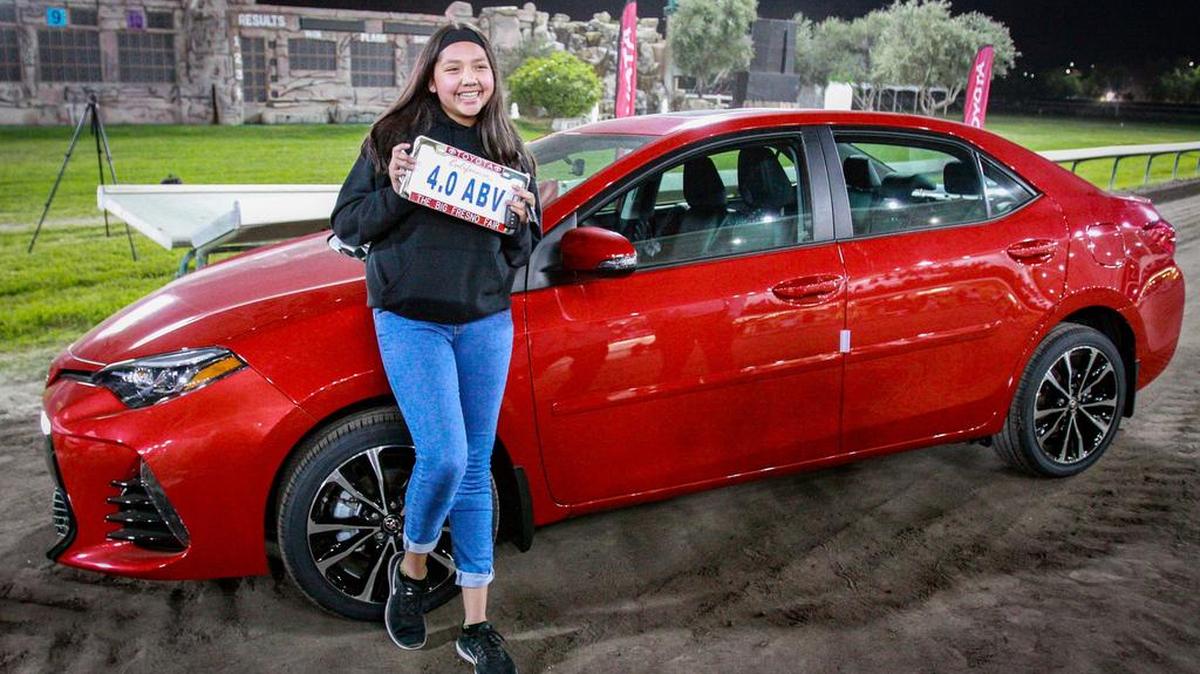 Michelle Salazar celebrates her new Toyota Corolla, a prize she won in a drawing among Fresno County students with 4.0 grade-point averages.