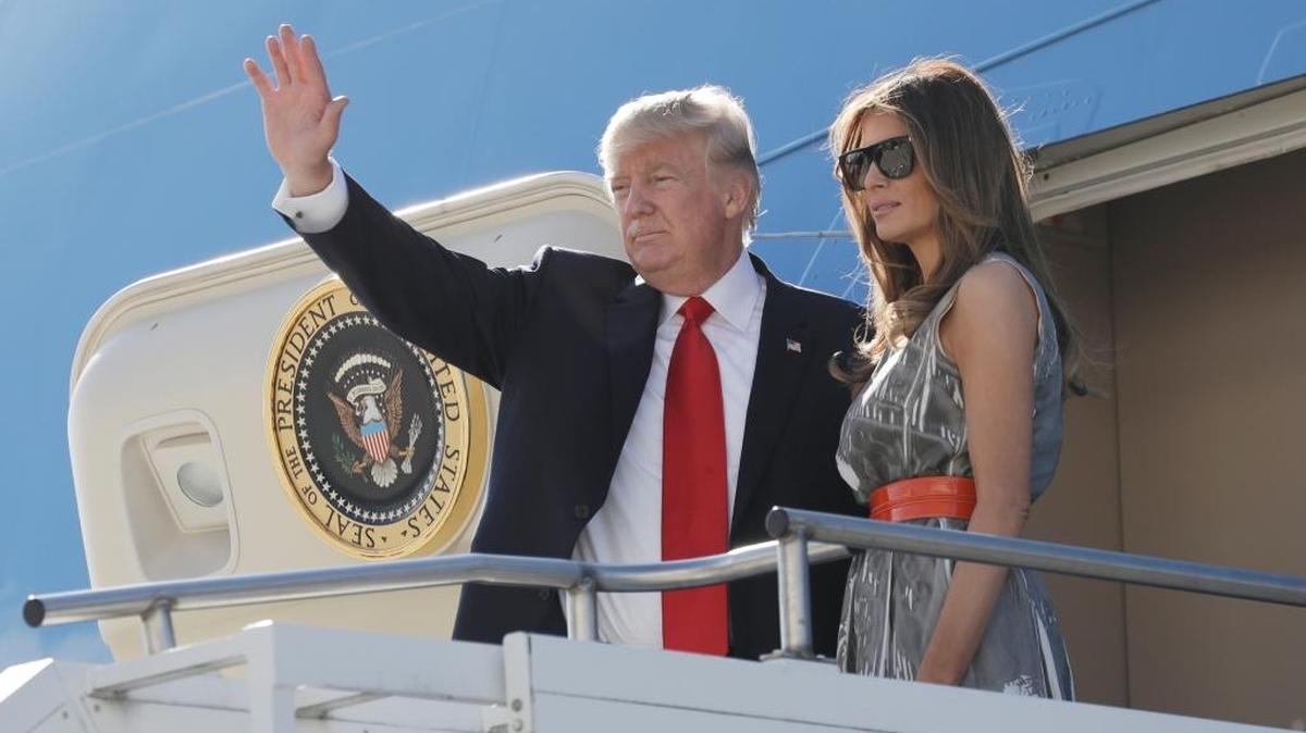 President Donald Trump, accompanied by first lady Melania Trump, waves as they board Air Force One in Hamburg, Germany, on July 8 following the G-20 Summit. On the flight to Washington, D.C., Trump reportedly dictated a statement about his son’s meeting with Russians.