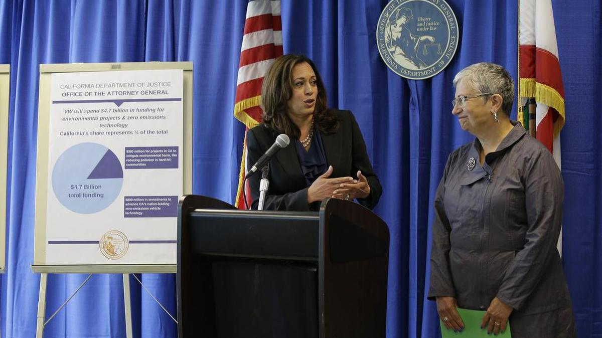 California Attorney General Kamala Harris, left, pays tribute to Mary Nichols, chair of the California Air Resources Board, while announcing a settlement with Volkswagen on Tuesday in San Francisco. Volkswagen will spend up to $15.3 billion to settle consumer lawsuits and government allegations that it cheated on emissions tests in what lawyers are calling the largest auto-related class-action settlement in U.S. history.