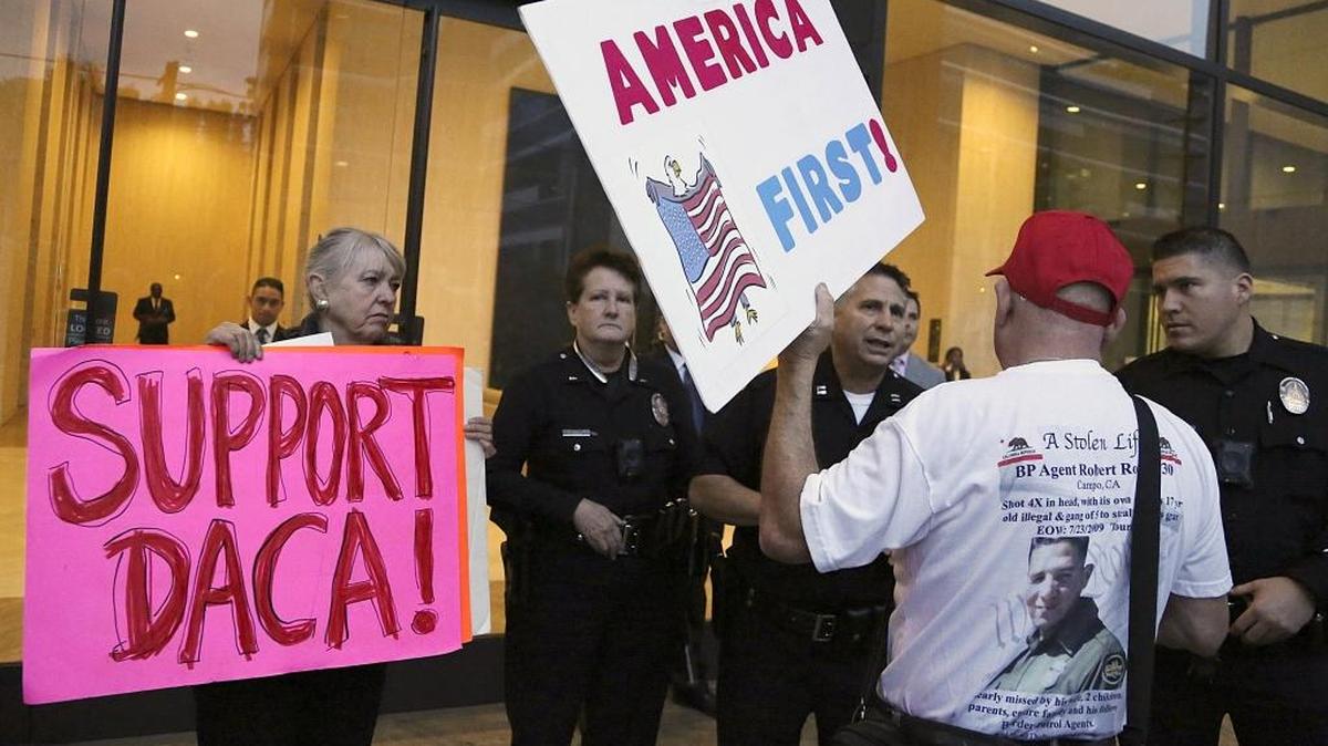 A supporter of President Donald Trump challenges police officers and a Deferred Action for Childhood Arrivals supporter outside Sen. Dianne Feinstein’s Los Angeles office earlier this month.