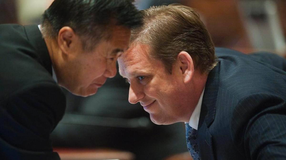 Then-state Sens. Leland Yee, left, and Tony Strickland confer during a debate on high-speed rail funding in 2012. Lee was sentenced to prison in February for accepting bribes and trafficking in arms. Strickland faces $80,000 in fines from the Fair Political Practices Commission.