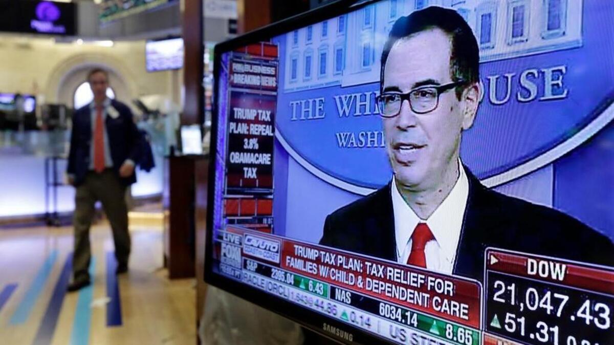 Treasury Secretary Steven Mnuchin appears on a television screen on the floor of the New York Stock Exchange on Wednesday as he outlines President Donald Trump’s proposals to cut corporate taxes.