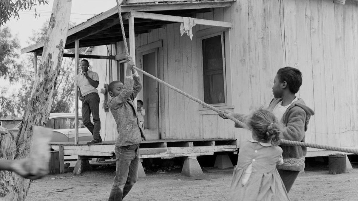 Benjamin Beavers watches his children play in front of their house in Teviston in 1961. A collection of photographs by Ernie Lowe will be shown in a new exhibit that opens from 4 p.m. to 8 p.m. Friday at the Fresno Art Museum. Lowe, a radio producer at KPFA in Berkeley in the 1960s, made nearly 1,000 photographs of Black Okies. The negatives have been printed by photographer and filmmaker Joel Pickford and curated by Michele Ellis Pracy, the museum’s executive director.