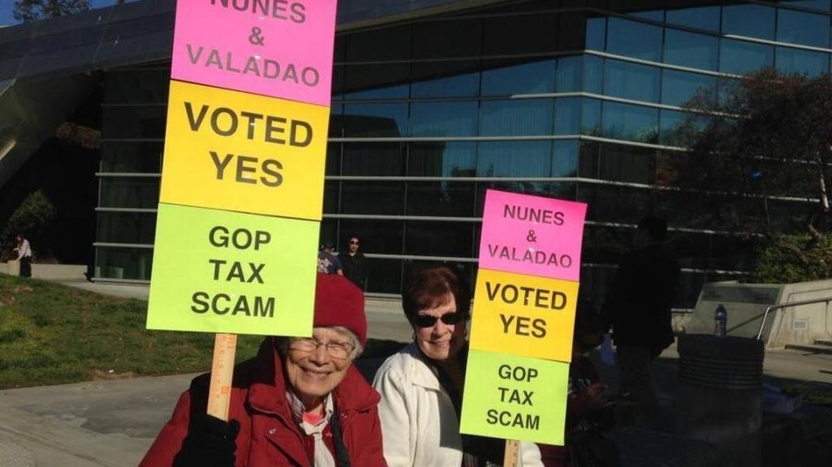 Ruth Afifi, 80, of Fresno, left, and Diane Woody, 73, of Fresno, at a rally in front of Fresno City Hall on Wednesday. Afifi, a retired adult-school teacher, said she is afraid money will be cut from Medicare to pay for proposed federal tax cuts.