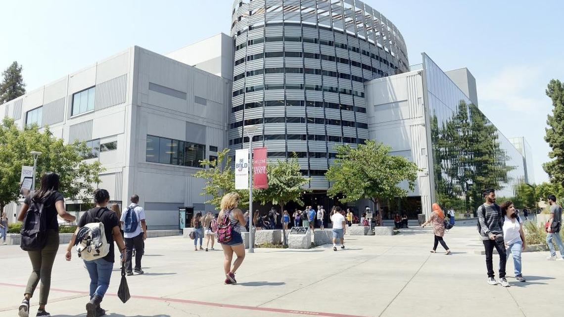 Students walk by the Madden Library at Fresno State.