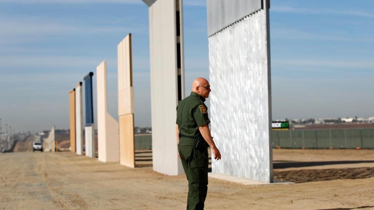 Mario Villarreal, the field office division chief for Customs and Border Protection, walks near border wall prototypes that were built east of San Ysidro on the border of Mexico on Nov. 20.