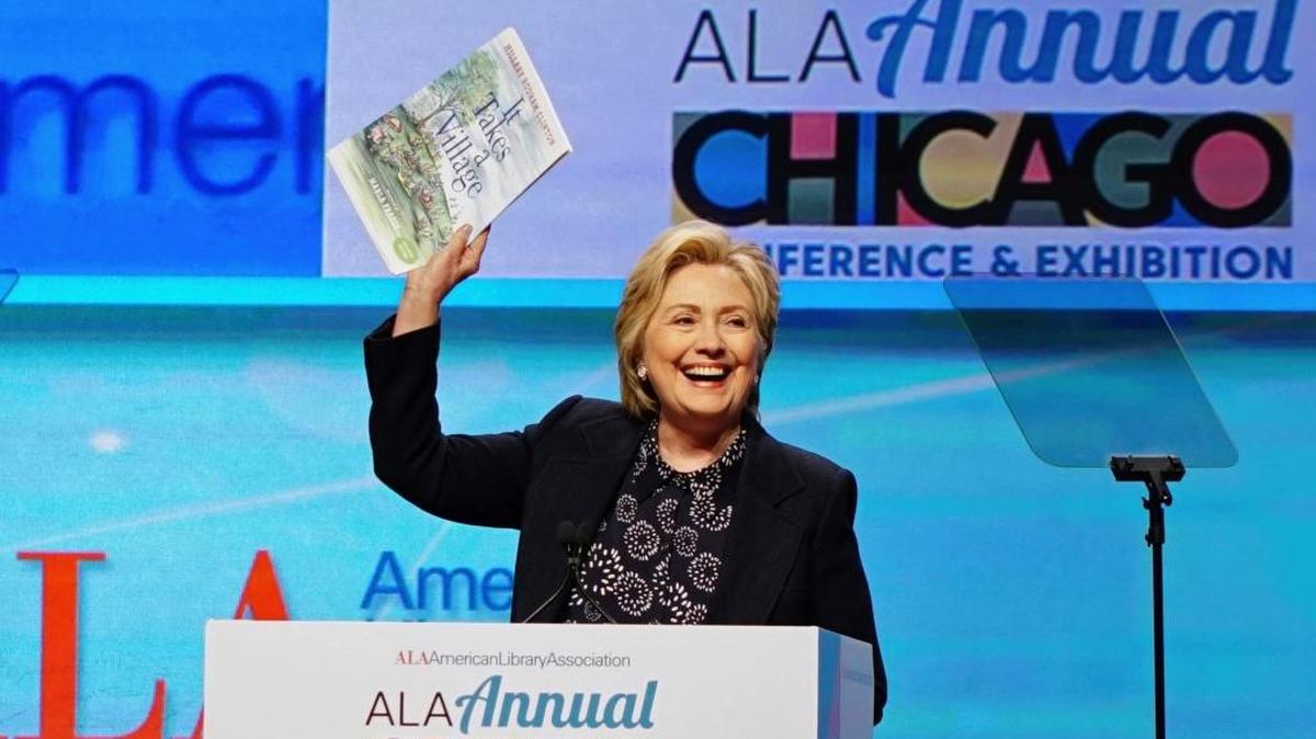 Hillary Clinton holds up an illustrated children’s version of her book, “It Takes a Village,” as she speaks at the American Library Association Annual Conference and Exhibition June 27 in Chicago. Democrats should just get over the fact that she was not a good candidate, says the Rev. Roger Minassian of Fresno.
