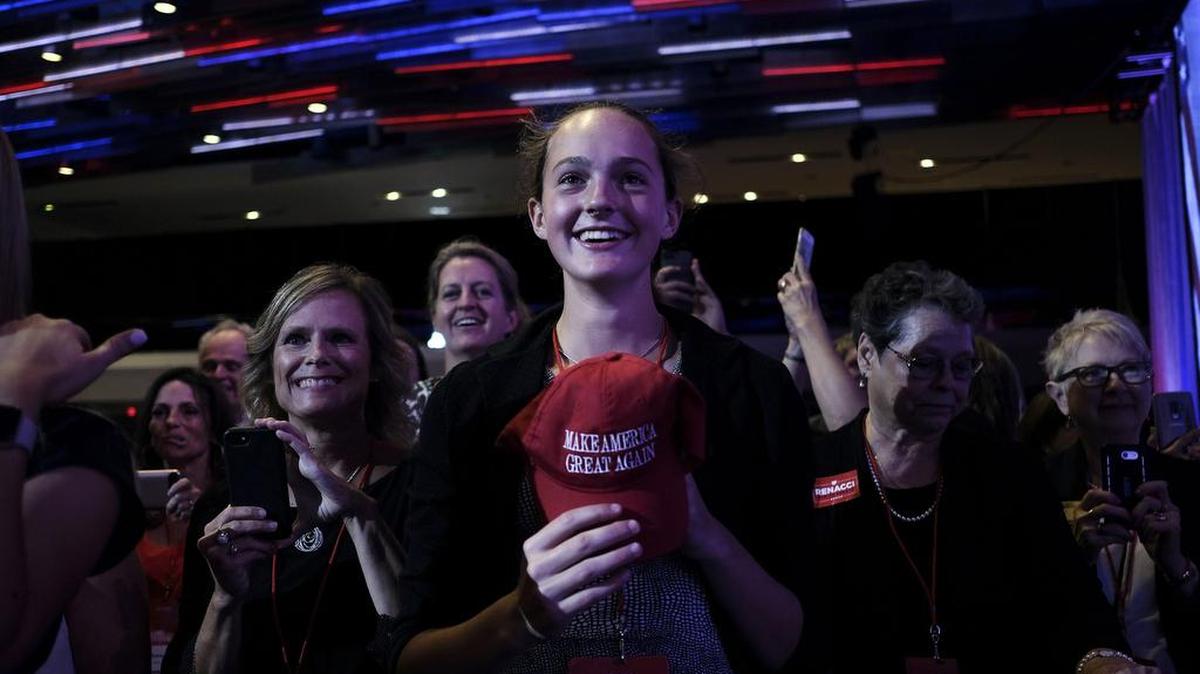 An attendee holds a “Make America Great Again” hat during remarks by President Donald Trump at the Ohio Republican Party State Dinner at the Greater Columbus Convention Center in Columbus, Ohio, on Aug. 24, 2018.