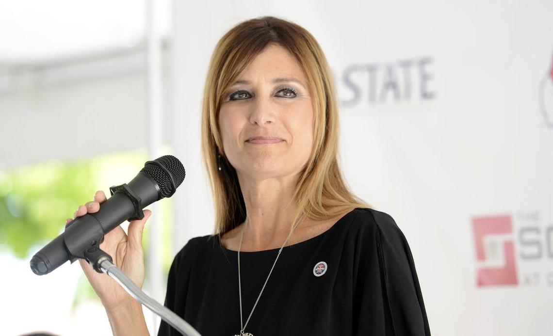 Debbie Astone, Associate Vice President and Executive Director of Auxiliary Services at Fresno State, gives the welcome message during the grand opening of The Square at Campus Pointe Friday, July 17, 2015.