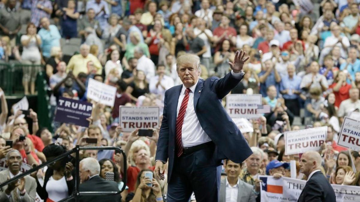 Then Republican presidential candidate Donald Trump waves to supporters after speaking at a campaign event in Dallas on Sept. 14, 2015.