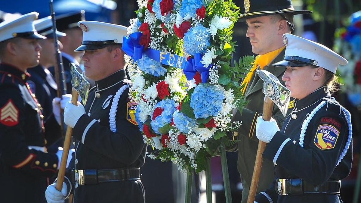 Honor guard members from Cal Fire and the Fresno County Sheriff’s Office carry a wreath honoring the New York City Fire Department during the remembrance service at the California 9/11 Memorial, Sept. 11, 2019.