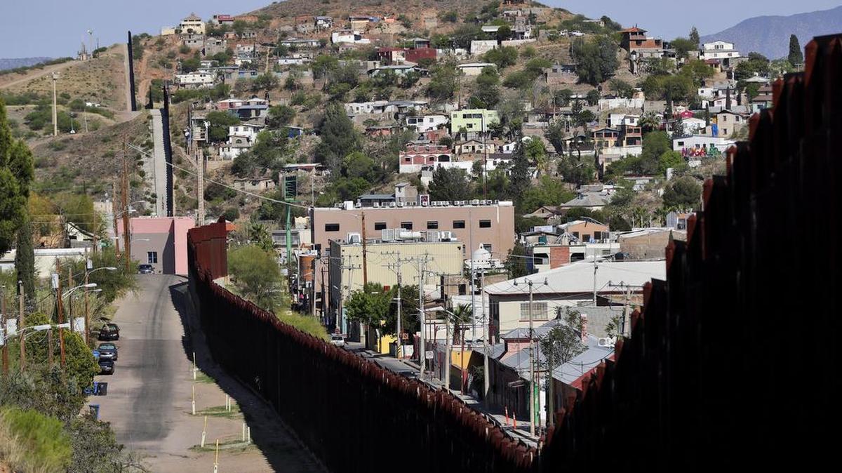In this April photo, the United States-Mexico international border between Nogales, Ariz., left, and Nogales, Sonora, Mexico. Arizona Gov. Doug Ducey says building a wall isn not the only way to provide security along the U.S.-Mexico border. Ducey noted that two-thirds of Arizona’s border already has some kind of wall or other physical barrier, but “there are other places where you go and walk right across ... and to me that’s a real concern.”
