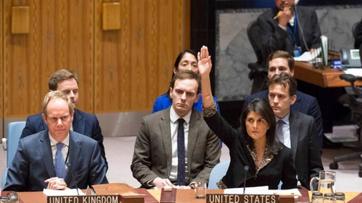 In this Monday, Dec. 18, 2017 photo, U.S. Ambassador to the United Nations Nikki Haley, right, votes against a resolution concerning Jerusalem's status at U.N. headquarters. The United States on Monday vetoed a resolution supported by the 14 other U.N. Security Council members that would have required President Donald Trump to rescind his declaration of Jerusalem as the capital of Israel, a vote that showed the depth of global opposition to the U.S. move.