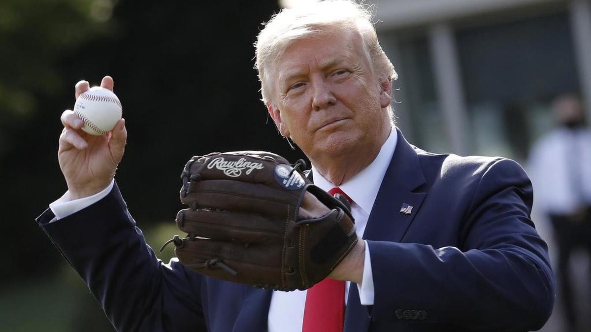 President Donald Trump plays catch to mark the Opening Day of the Major League Baseball Season on the South Lawn of the White House in Washington, D.C., on Thursday, July 23, 2020.