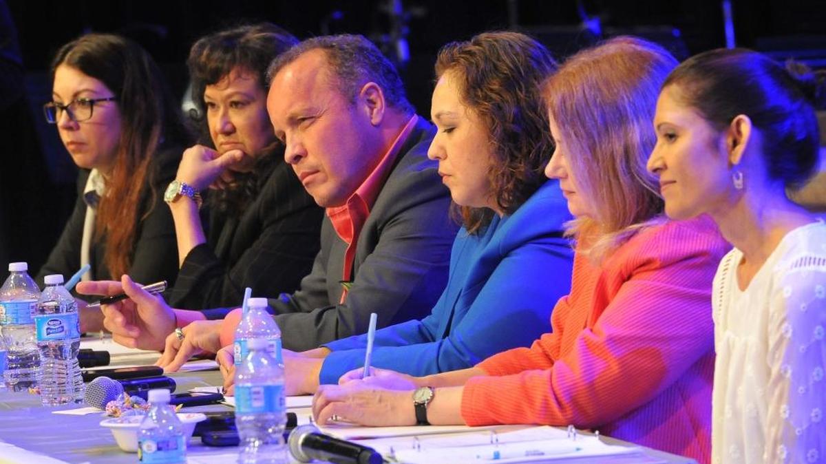 Tish Rice, right, Fresno Teachers Association president, with FUSD trustees, from left, Elizabeth Jonasson Rosas, Valerie Davis, Brooke Ashjian, Claudia Cazares and Carol Mills, listens to comments from the audience during during the Fresno Teachers Association’s “Summit on the Future of FUSD,” at People’s Church March 28.