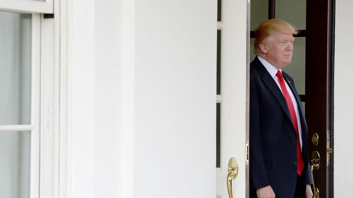 U.S. President Donald Trump looks out the West Wing of the White House on March 30, 2017.