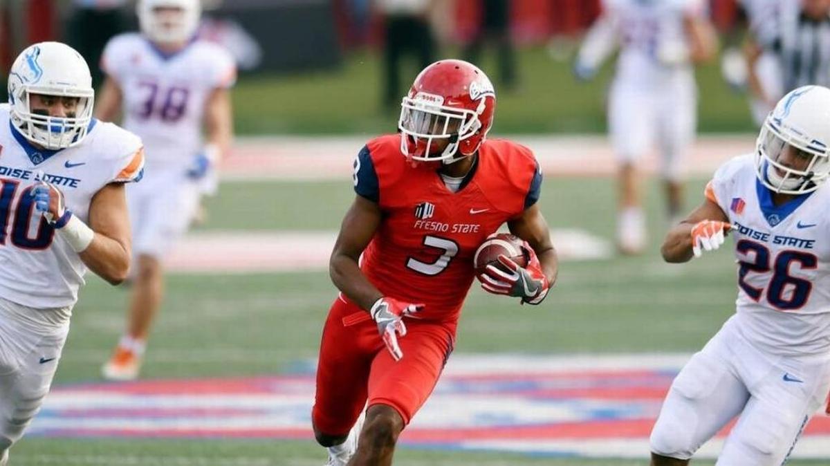 Fresno State’s KeeSean Johnson runs for a touchdown with Boise State’s Kekoa Nawahine, left, and Avery Williams struggling to keep up last Saturday.