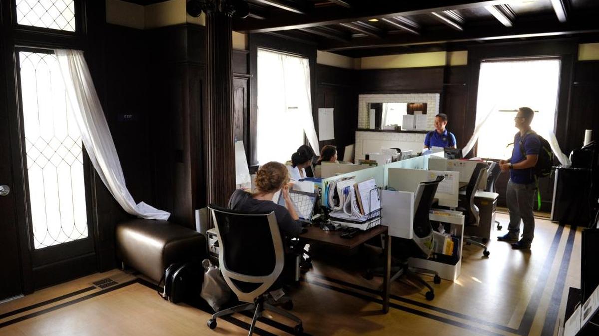 AmeriCorps workers at their workstations inside the historic Helm Home which has won a California Historic Preservation Award for the restoration work. The Helm Home, currently home to four organizations, is located along L Street just south of Divisadero Street in uptown Fresno.