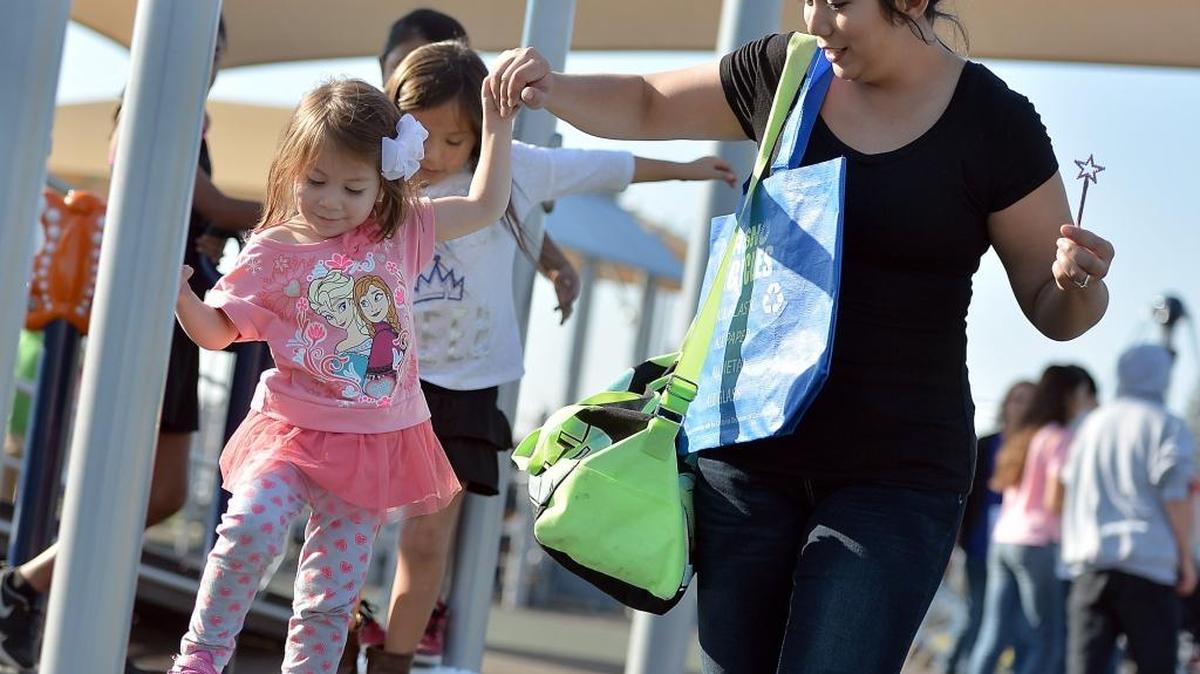 Alaina Wilson and her mother, Maile, both of Fresno, celebrate the grand opening of the universally accessible Inspiration Park on in 2015.