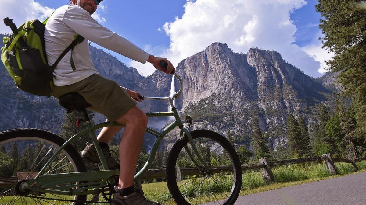 Chris Witmer from central Florida rides a rented bike with his family through Yosemite Valley Tuesday, June 4, 2019 in Yosemite National Park.
