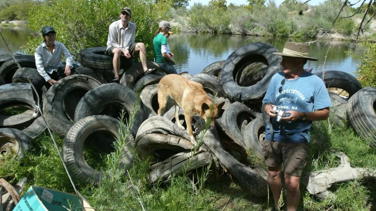 At right, Richard Sloan, co-founder of RiverTree, a volunteer group from Fresno dedicated to river restoration, stand next to a pile of tires he and a group of volunteers pulled out of the San Joaquin River in 2005.