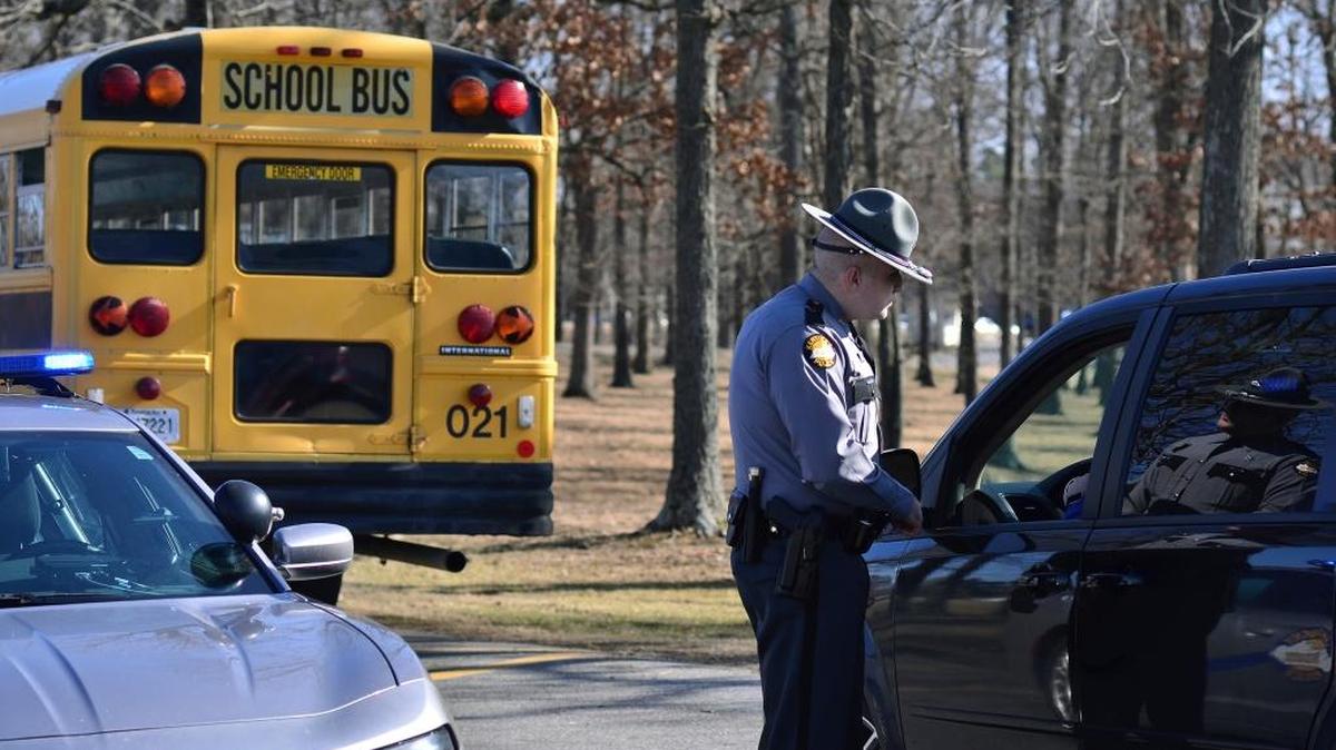 A Kentucky State Police trooper checks with a motorist entering Marshall County High School Wednesday, Jan. 24 near Benton, Ky. Two students died and another 18 people were injured in a shooting on Tuesday.