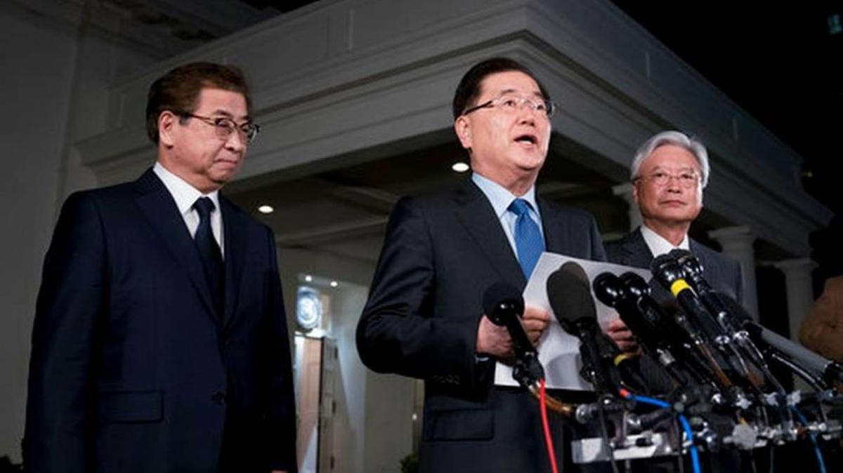 South Korean national security director Chung Eui-yong, center, speaks to reporters at the White House in Washington, Thursday, March 8, 2018, as intelligence chief Suh Hoon, left and Cho Yoon-je, the South Korea ambassador to United States, listen. Could this be a step toward Korean reunification?