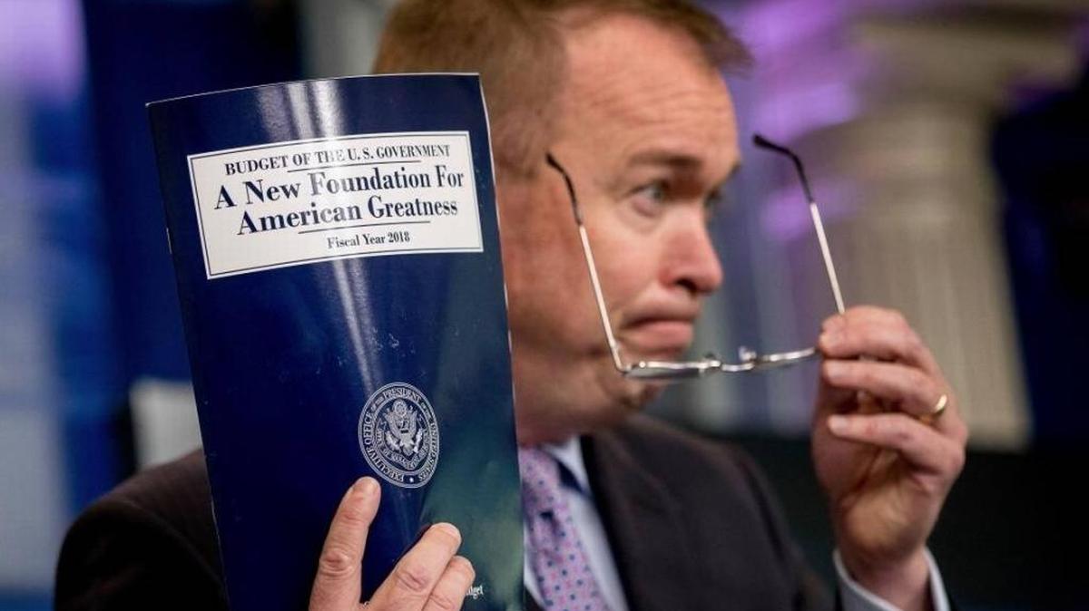 Budget Director Mick Mulvaney holds up a copy of President Donald Trump’s proposed fiscal 2018 federal budget as he speaks to the media May 23, 2017.
