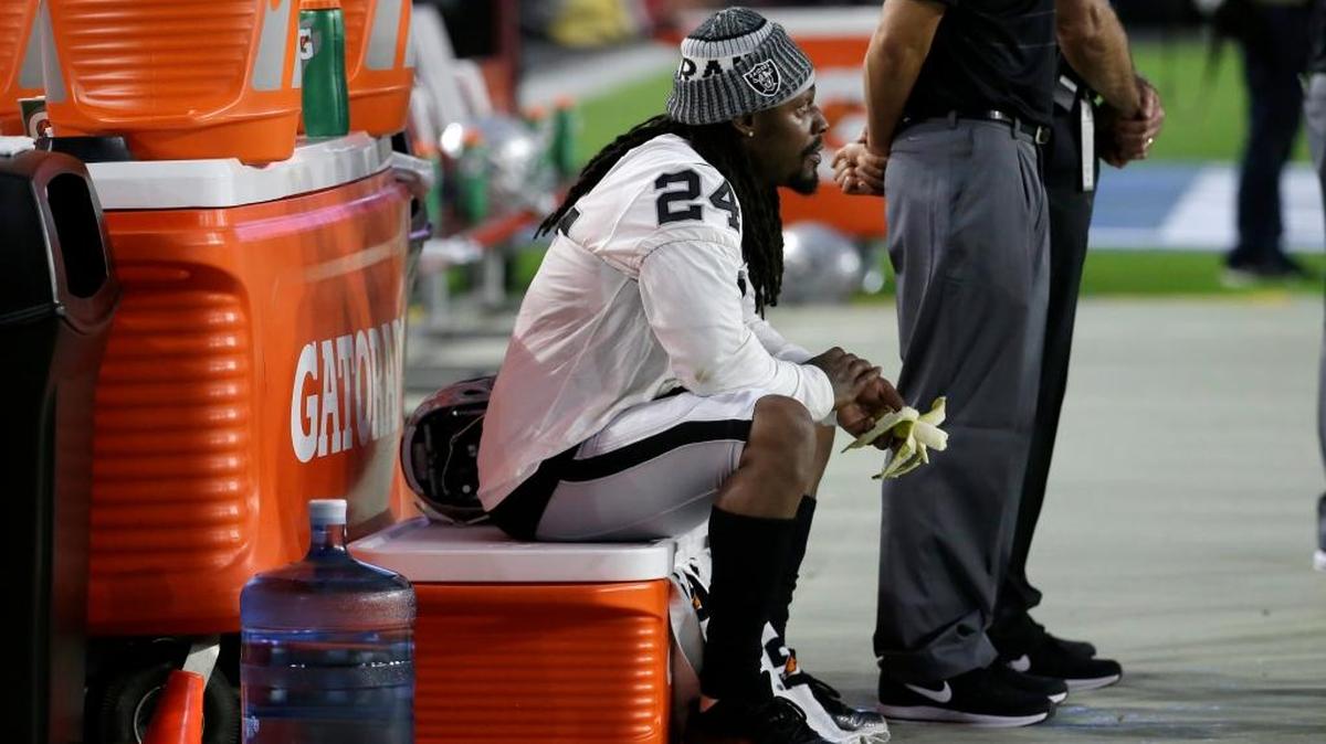 Oakland Raiders running back Marshawn Lynch (24) sits during the national anthem prior to an NFL preseason football game against the Arizona Cardinals Aug. 12. Joanne Hawkins believes he should not play if he cannot stand for the anthem.