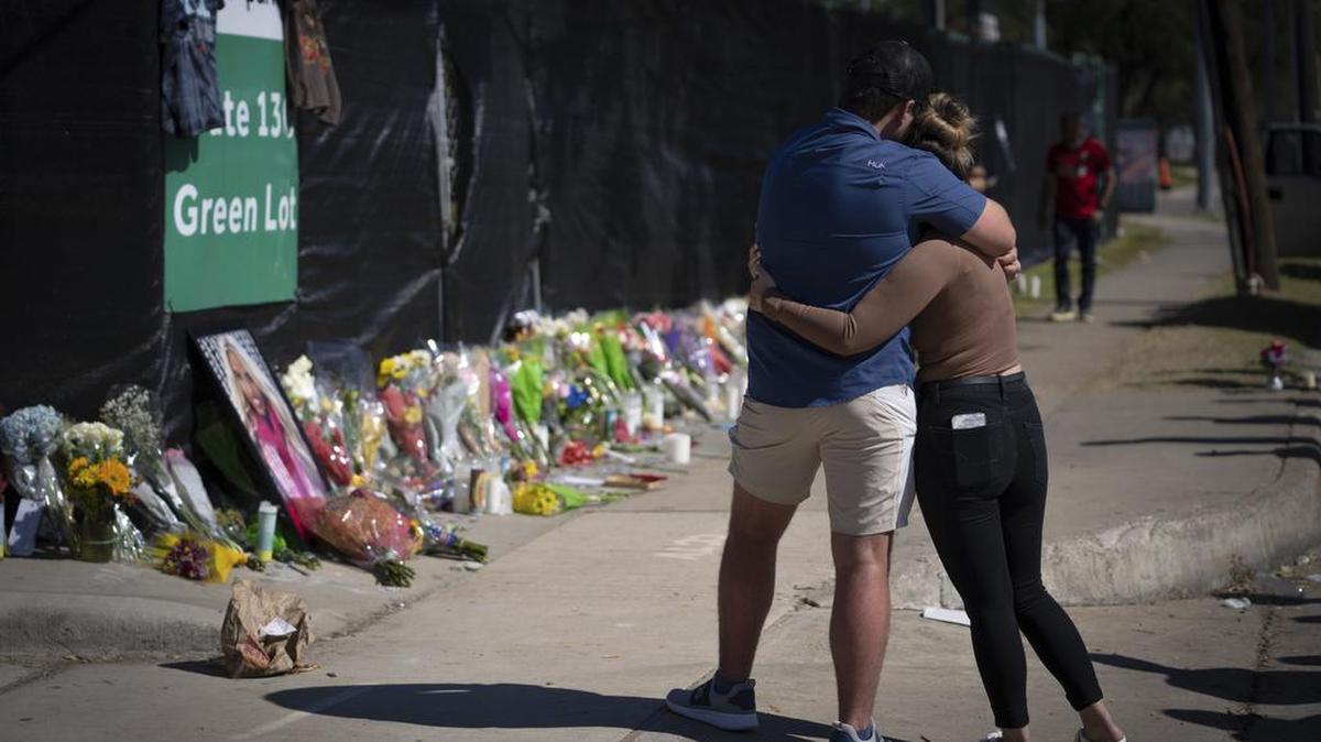 Two people who knew an unidentified victim of a fatal incident at the Houston Astroworld concert embrace at a memorial on Sunday, Nov. 7, 2021. The family of two close friends from suburban Chicago who were killed at the Astroworld concert in Houston this month have filed wrongful death lawsuits against rapper Travis Scott, the Live Nation entertainment company and others.