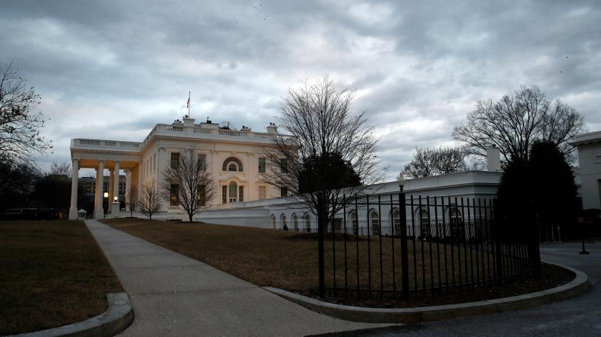The White House is seen under a cloudy sky Sunday, Jan. 21, 2018, in Washington. The White House says President Donald Trump has spoken with House Majority Leader Kevin McCarthy and Senate GOP Whip John Cornyn on the second day of a government shutdown. The White House put out a brief statement Sunday detailing the president's activities, saying the administration was hard at work. (AP Photo/Alex Brandon)