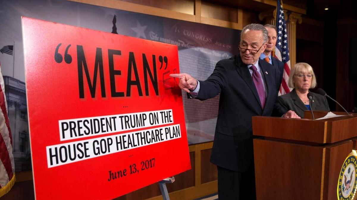 Senate Minority leader Chuck Schumer, D-New York, shows off his poster to explain what he thinks of the health care bill unveiled by his Republican colleagues.