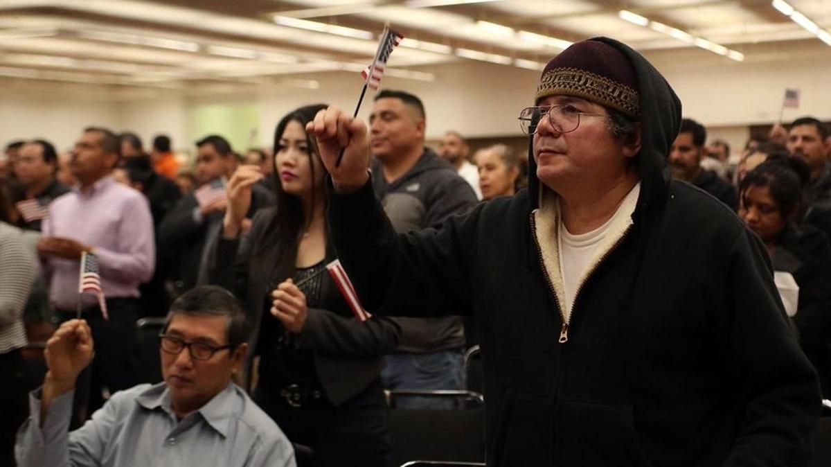 José Maza of El Salvador waves a small American flag at the naturalization ceremony for 489 immigrants from 45 countries at the Fresno Convention Center on Jan. 10. The ceremony was conducted by the U.S. Citizenship and Immigration Services.