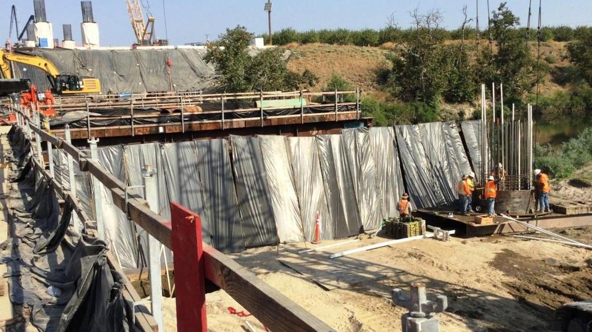 Construction crews work on building a new high-speed rail bridge over the San Joaquin River at the north end of Fresno on Oct. 17.