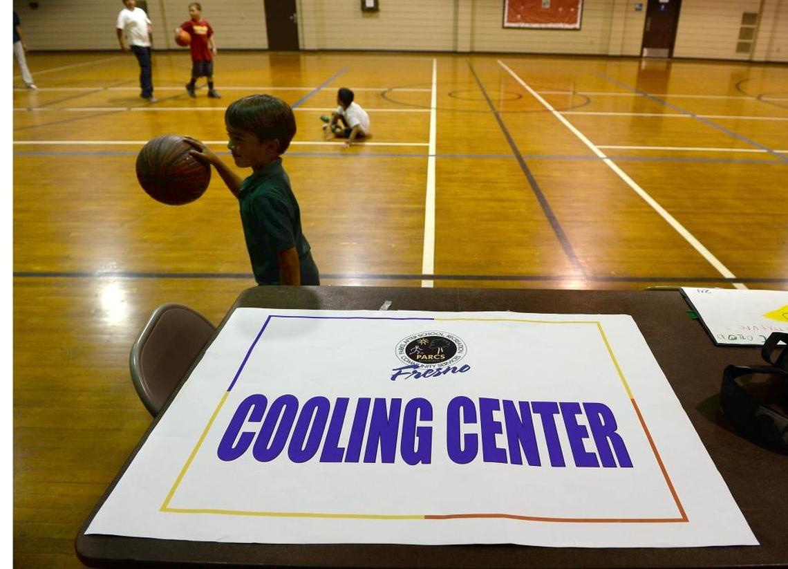 Kids play basketball at Ted C. Wills Community Center, one the four cooling centers in the city of Fresno.