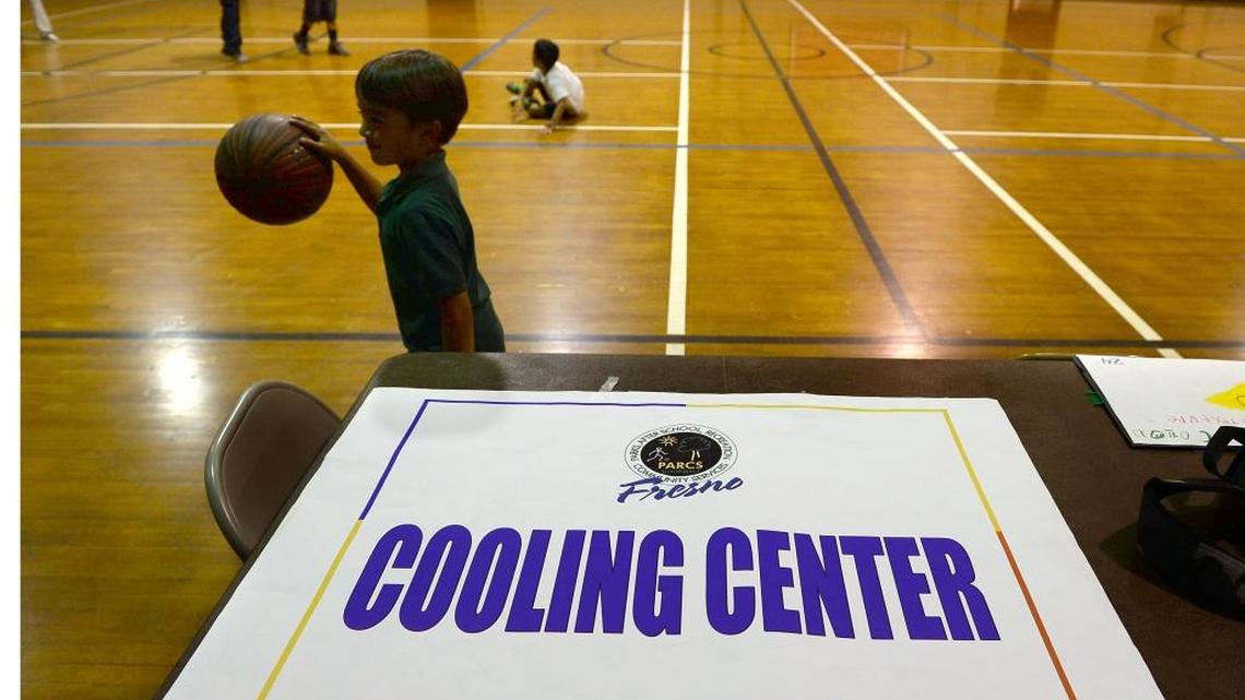 Kids play basketball at Ted C. Wills Center, on 770 N San Pablo Ave, Fresno which is one the four cooling centers in the city of Fresno.