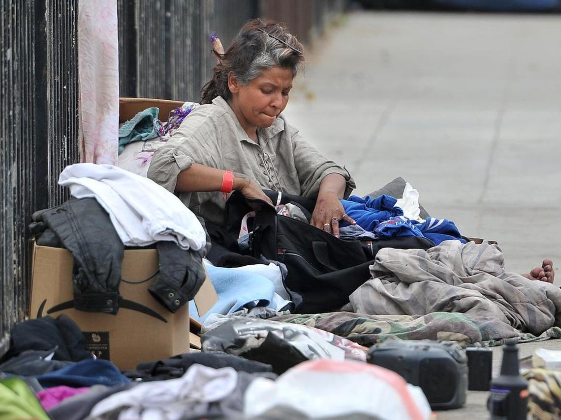 Near the California Poor People’s Campaign rally held near the Poverello House, a homeless woman sorts her belongings, Monday April 8, 2019.