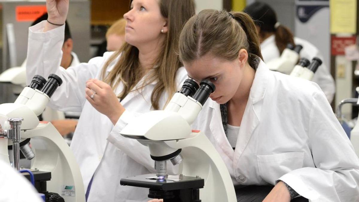 Space is at a premium, as Fresno City College students Joelle Feest, left, and Kylee Langdon work side-by-side in their microbiology lab in the aging Math and Science Building. It would be replaced with passage of the Measure C bonds.