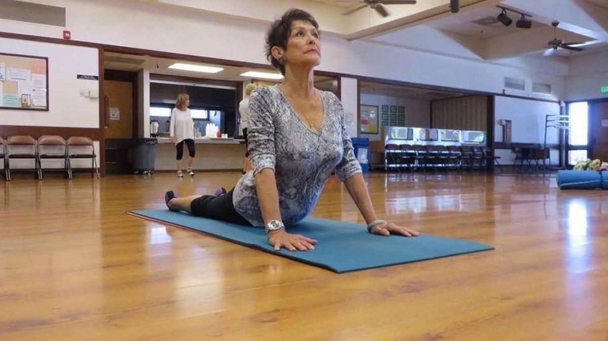 Eva Shanoian performs a cobra pose in a restorative yoga class at the Clovis Senior Activity Center in July 2016.