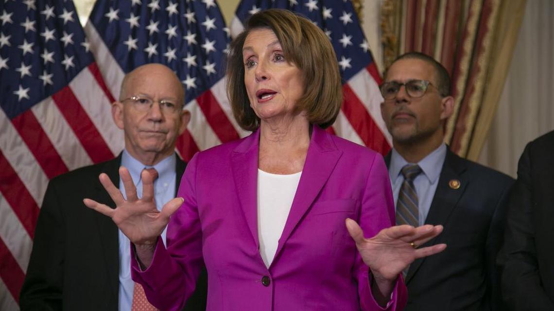 Speaker of the House Nancy Pelosi, D-San Francisco, is flanked by Rep. Peter DeFazio, D-Ore., left, and Rep. Anthony Brown, D-Md., as she talks to reporters after signing a House-passed a bill requiring that all government workers receive retroactive pay after the partial shutdown ends.
