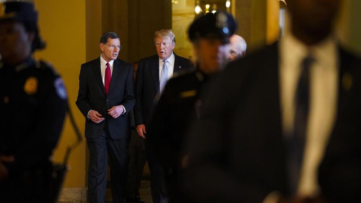 President Donald Trump walks with Sen. John Barrasso, R-Wyo., at the U.S. Capitol in Washington in May 2018. Barrasso, who is from uranium-rich Wyoming, has introduced a bill to promote nuclear power that he frames as a climate solution. Driven partly by polls showing voters in both parties — particularly younger ones — are worried about a warming planet, some lawmakers are changing how they talk about climate change.