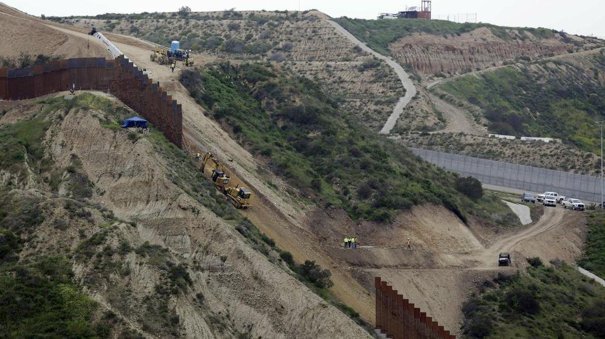 In this March 11, 2019 photo, construction crews replace a section of the primary wall separating San Diego, above right, and Tijuana, Mexico, below left. The Pentagon has sent a 20-page list of military construction projects to lawmakers who want to know which might be cut to pay for President Donald Trump’s wall along the border with Mexico. Democrats say the list shows that Trump is willing to cut needed defense spending and make the U.S. less secure, just to finance his wall. Trump has vetoed legislation aimed at blocking the cuts.