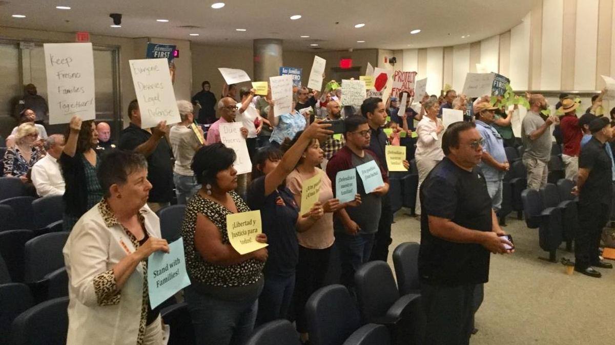 Supporters of a proposal to aid undocumented immigrants facing possible deportation hold signs at the Fresno City Council meeting June 20, 2017. The proposal was voted down 4-2 with Councilman Louis Chavez abstaining.