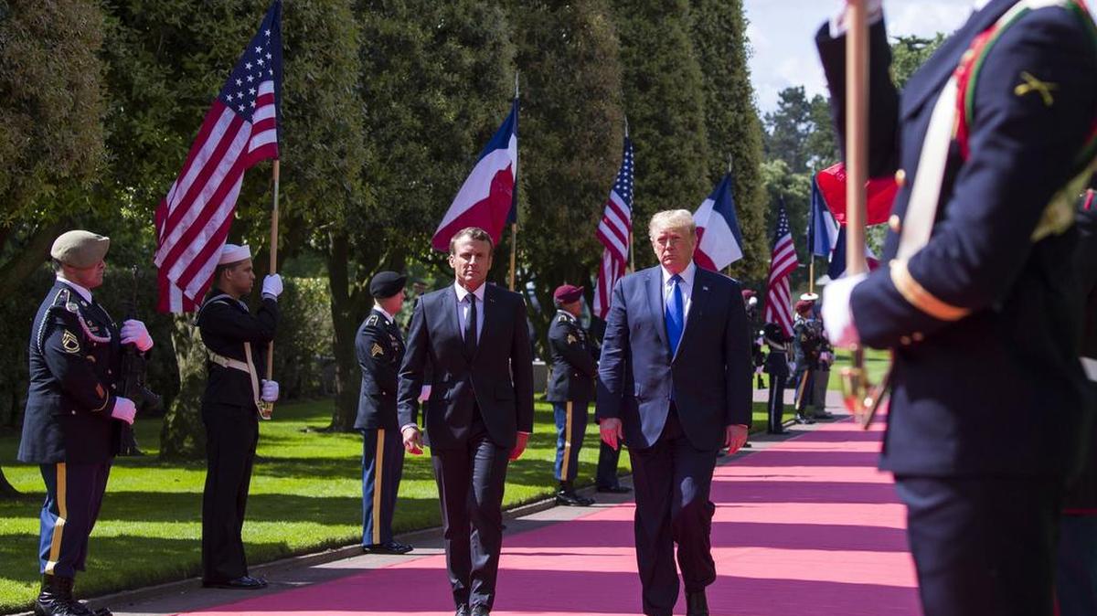 French President Emmanuel Macron, left, and President Donald Trump arrive for a ceremony to commemorate the 75th anniversary of D-Day at the American Normandy cemetery, Thursday, June 6, 2019, in Colleville-sur-Mer, Normandy, France.