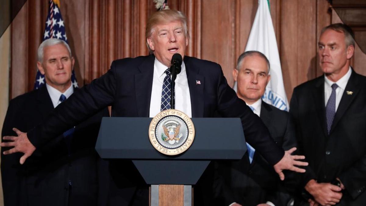 President Donald Trump, accompanied by from left, Vice President Mike Pence, Environmental Protection Agency Administrator Scott Pruitt, and Interior Secretary Ryan Zinke, speaks prior to signing an executive order March 28, 2017, that unravels former President Barack Obama’s plan to curb global warming.