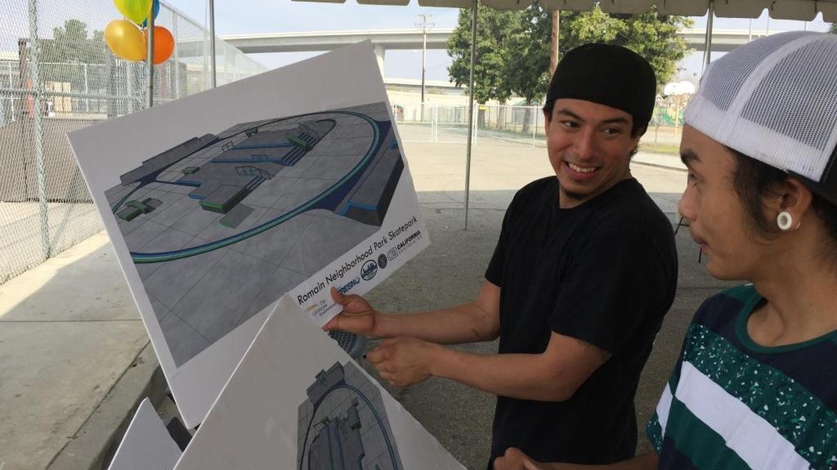 Two of the approximately 250 youth and skaters who provided input to the skate park under construction at Romain Park examine the plans.